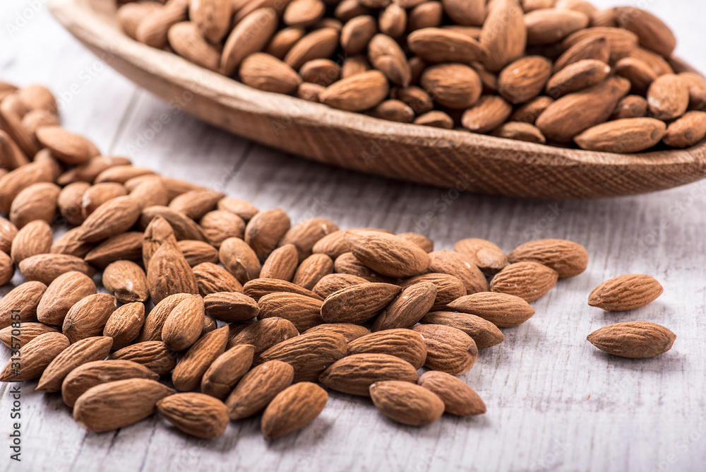 Almonds nut on white wooden table. Almond healthy raw food. Almonds nut on white wooden table. Almond healthy raw food.