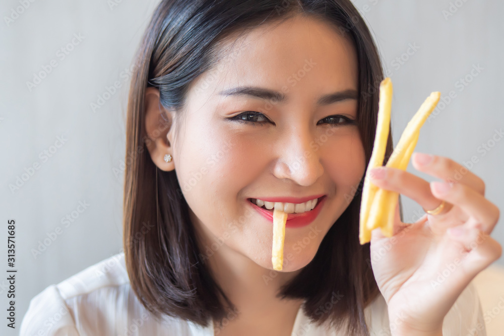 hungry woman looking, eating fried potato, french fries, chips; concept of health care, eating habit, unhealthy junk food, delicious food, fast food hungry woman looking, eating fried potato, french fries, chips; concept of health care, eating habit, unhealthy junk food, delicious food, fast food
