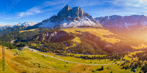 Stunning view of Peitlerkofel mountain from Passo delle Erbe in Dolomites, Italy. View of Sass de Putia (Peitlerkofel) at Passo delle Erbe, with wooden farm houses, Dolomites, South Tyrol, Italy.