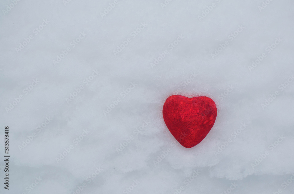 Red stone heart in artificial snow Red stone heart in artificial snow