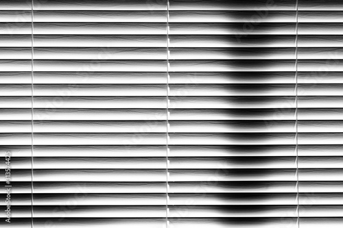 Abstract Venetian Blinds Background, light and shadows on white wooden slats, window covering.