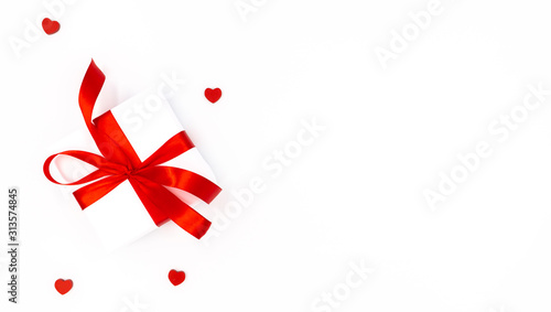 Gift and little red hearts on a white background. Lots of free space. Valentine's day, birthday, mother's day.
