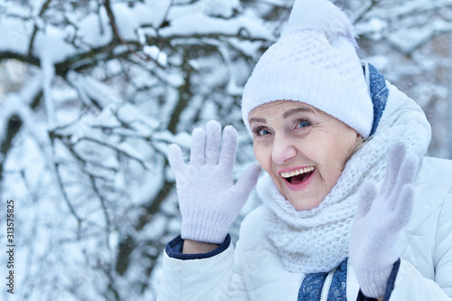 Happy beautiful senior woman in warm hat