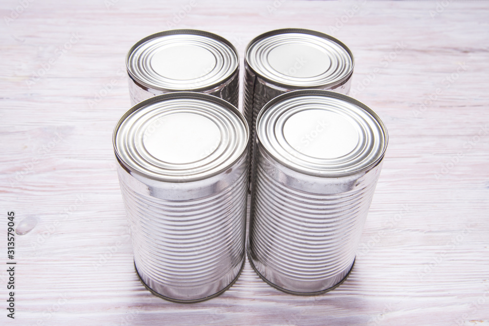 Set of metal tin cans on wooden table Set of metal tin cans on wooden table