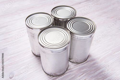 Set of metal tin cans on wooden table