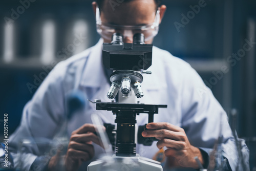 Young scientist looking thr...