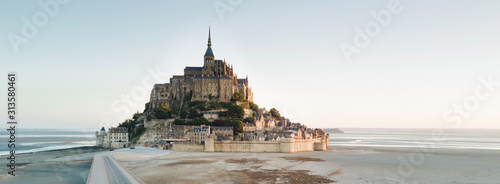 Le Mont Saint Michel tidal island in beautiful twilight at dusk, Normandy, France shot from aerial perspective