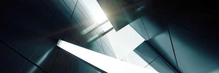 Wide angle abstract background view of steel light blue high rise commercial building skyscraper made of glass exterior. concept of successful industrial architecture and office center building