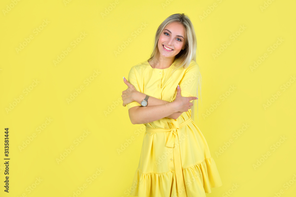 beautiful young woman in a yellow dress on a yellow background beautiful young woman in a yellow dress on a yellow background