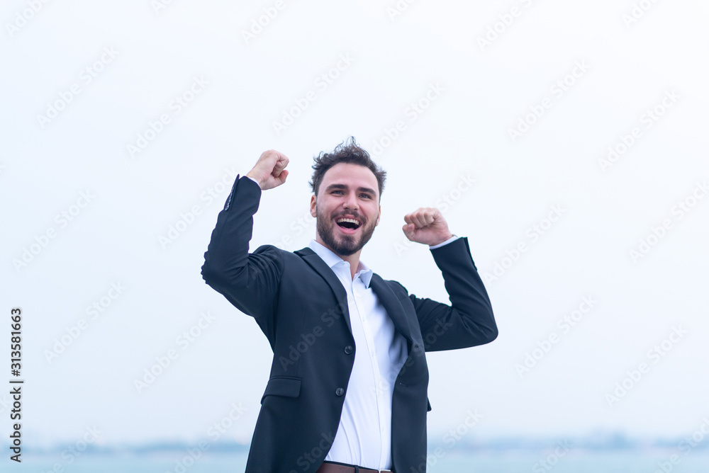 A young businessman who is happy for the success of the business A young businessman who is happy for the success of the business