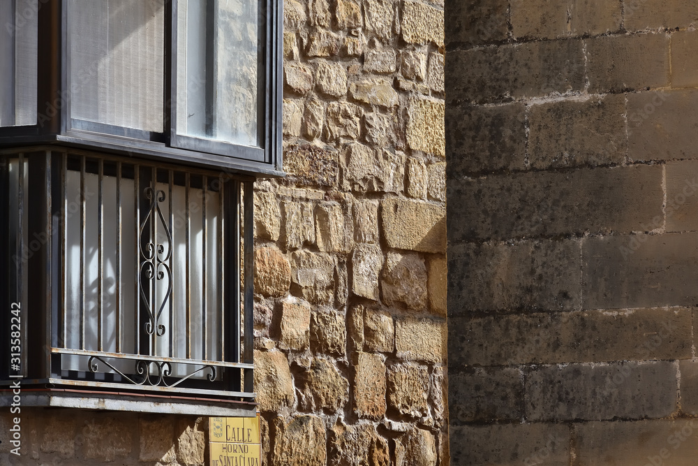 Obraz premium Lights and shadows at the crossroads of two historic streets of a World Heritage city with a sunlit balcony