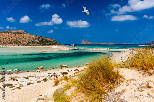 Balos Lagoon and Gramvousa island on Crete with seagulls flying over, Greece. Cap tigani in the center. Balos beach on Crete island, Greece. Crystal clear water of Balos beach.