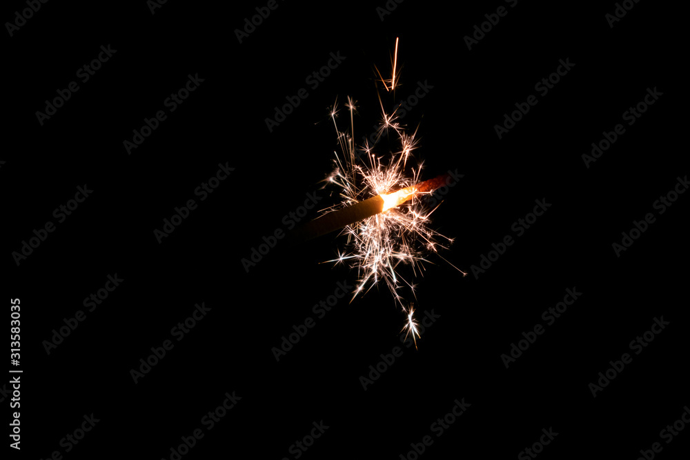 Sparklers burn in the dark, creating a festive mood.