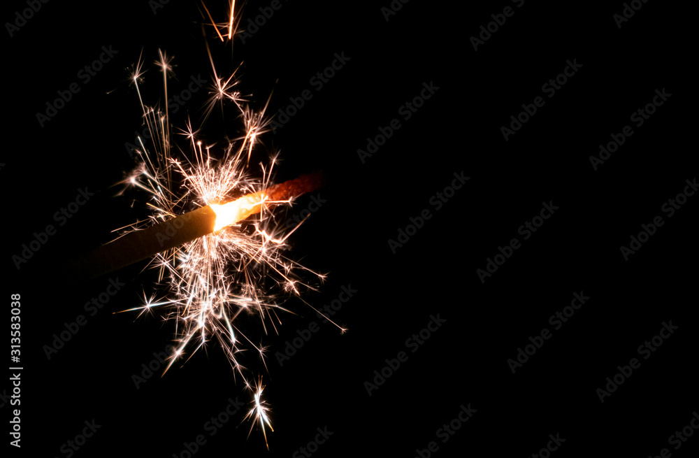Sparklers burn in the dark, creating a festive mood.