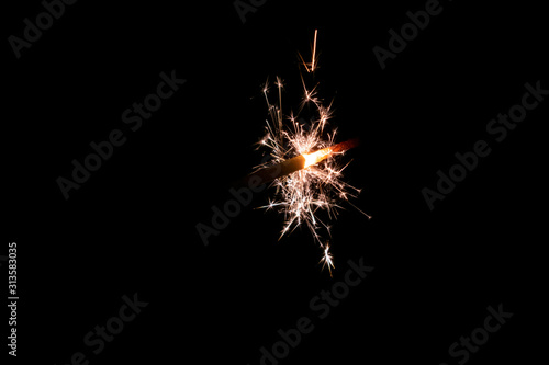 Sparklers burn in the dark  creating a festive mood.
