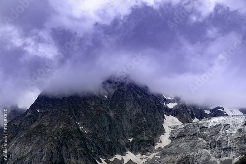 Alpine summits near Mont Blanc in clouds, Italy side.