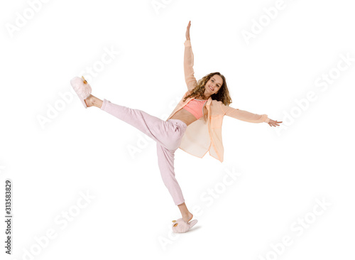 Young woman having fun dancing on a white
