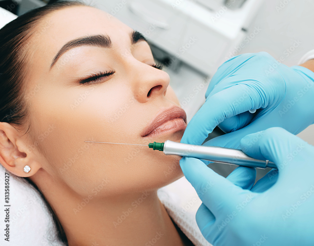 woman rejuvenates face using cosmetic procedures. Facial injections make the skin smooth and young. macro woman rejuvenates face using cosmetic procedures. Facial injections make the skin smooth and young. macro