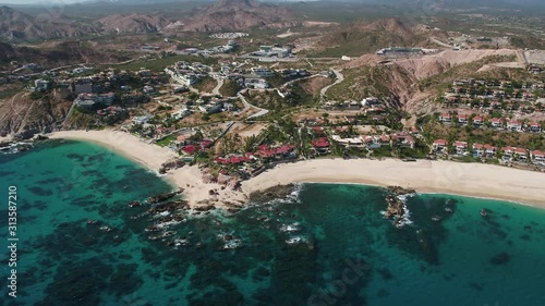 Jose del Cabo Palmilla homes and coast aerial Mavic 2 Zoom H.264. Tilt up to reveal mountains. Turquoise water and coral reefs. High Angle photo