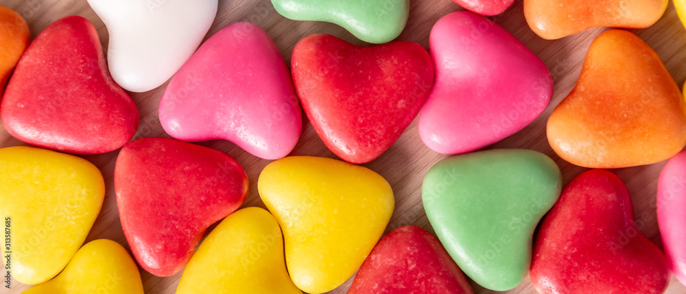 Valentines Day background with hearts shaped on a wooden table Valentines Day background with hearts shaped on a wooden table