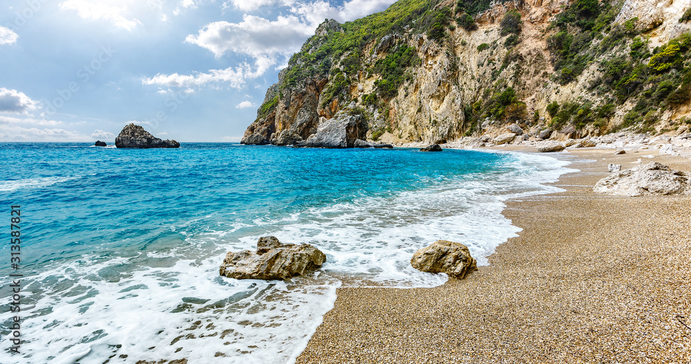 Scenic nature Seascape. Landscape of Ionian Sea. Seashore with cliffs, waves crashing on rocks.  Adventures and exotic travel concept. Wonderful summer view. Amazing Natural Background