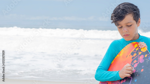 surfer boy preparing surf board