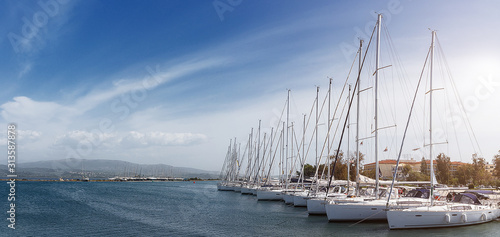 Wonderful morning landscape of Ionian Sea. Awesome Sunny seascape with luxury Yachts in bay and perfect sky. Adventures and exotic travel concept. Wonderful summer view photo