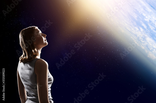 Girl looking at Earth planet