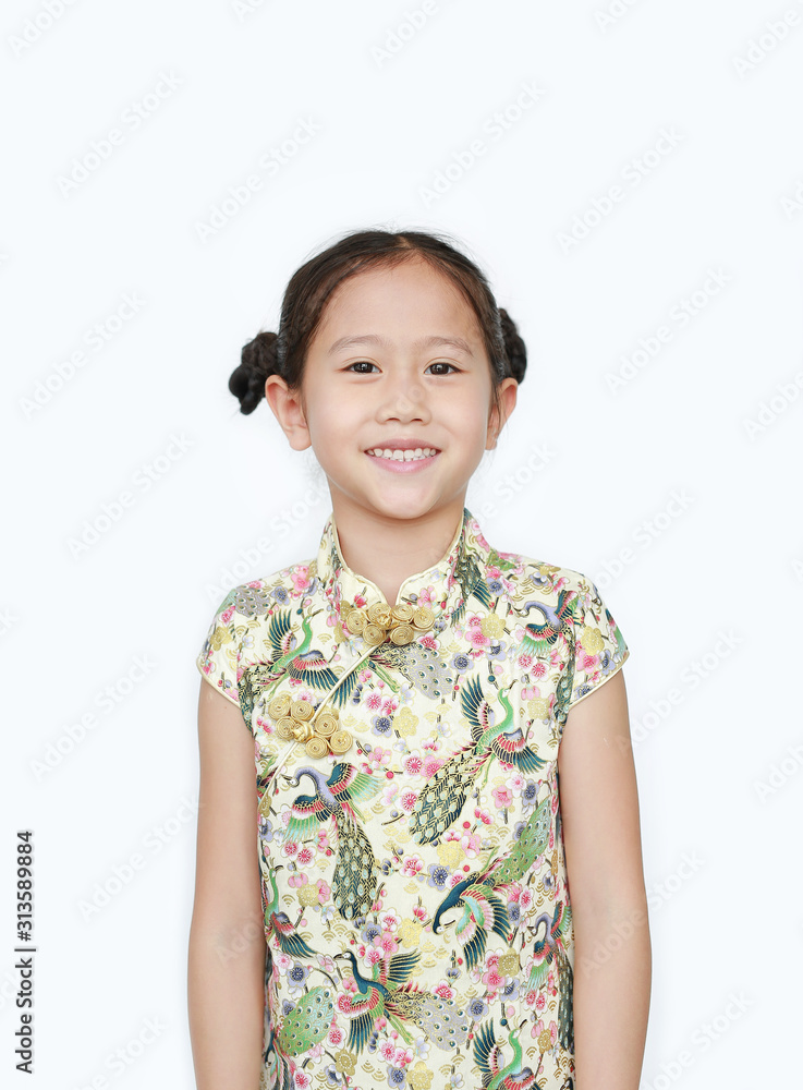 Portrait of happy little Asian girl wearing cheongsam with smiling over white background. Happy Chinese New Year.