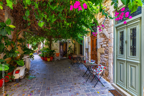 Fototapeta Naklejka Na Ścianę i Meble -  Street in the old town of Chania, Crete, Greece. Charming streets of Greek islands, Crete. Beautiful street in Chania, Crete island, Greece. Summer landscape. Chania old street of Crete island Greece.