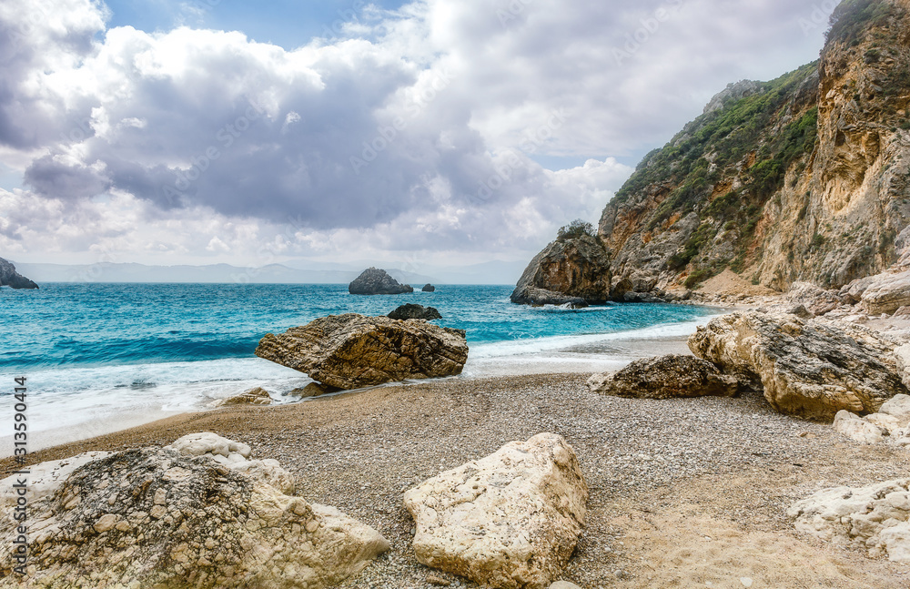 Scenic nature Seascape. Landscape of Ionian Sea. Seashore with cliffs, waves crashing on rocks.  Adventures and exotic travel concept. Wonderful summer view. Amazing Natural Background