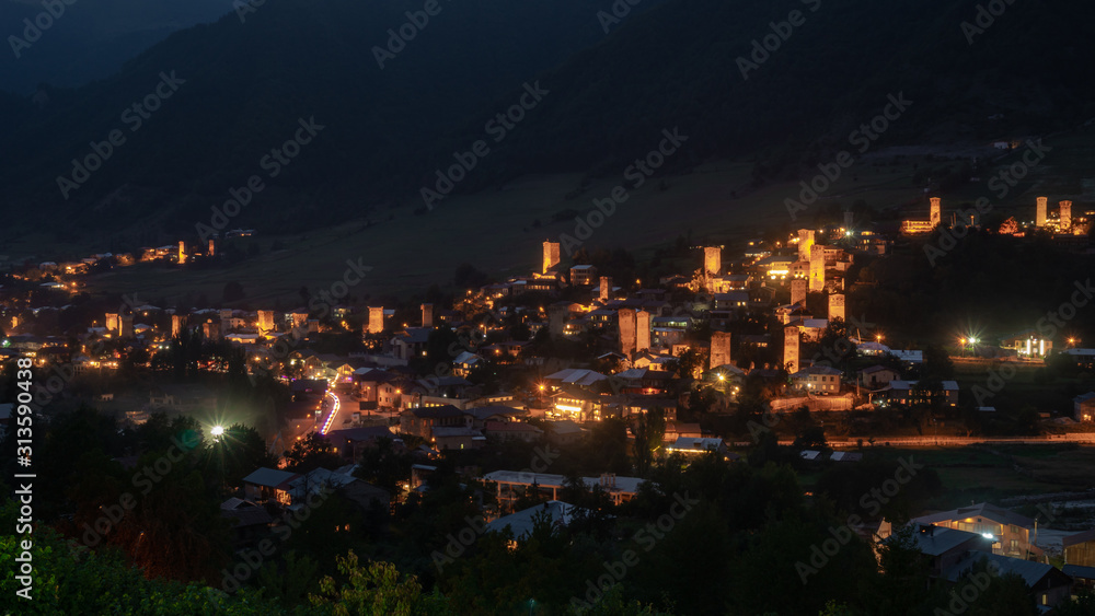 Night view on Mestia with its illuminated Svan Towers. Svaneti, Georgia.
