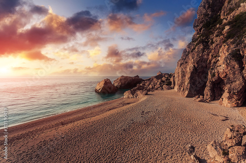 Awesome seascape during suunset. Beach, calm sea and colorful sky. Summer view of Kathisma Beach. Wonderful nature scene of Lefkada Island, Greece. Adventures and exotic travel concept. photo