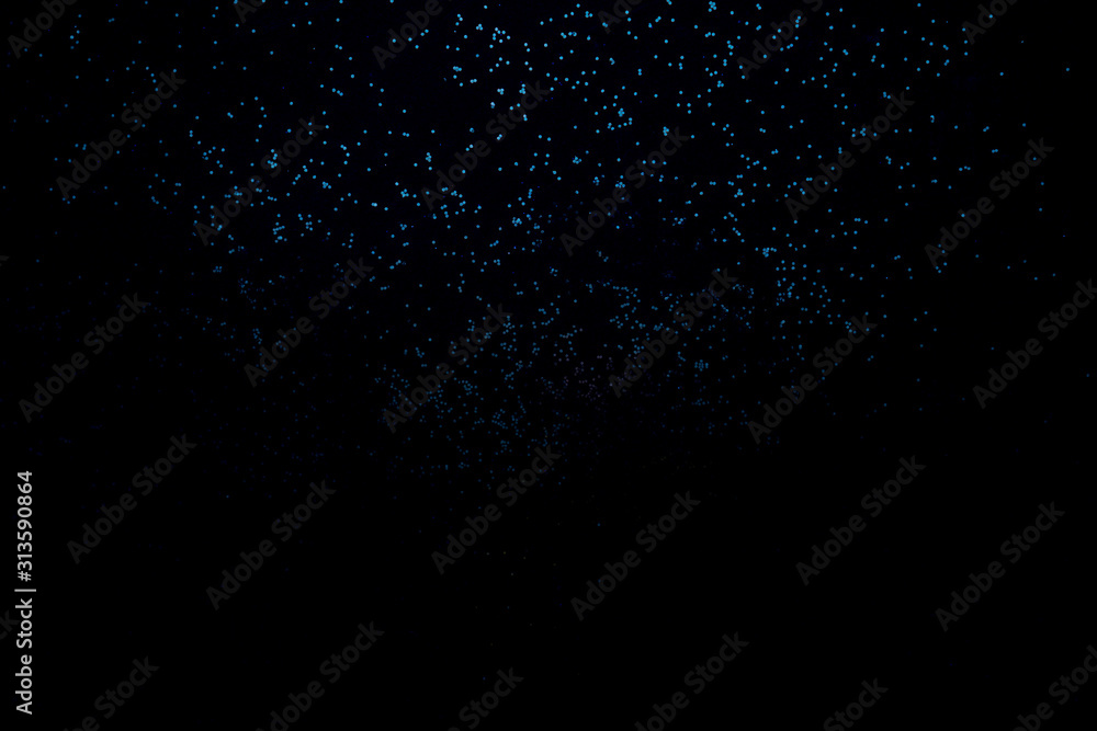 Blue shiny background of sparkles. Festive concept.