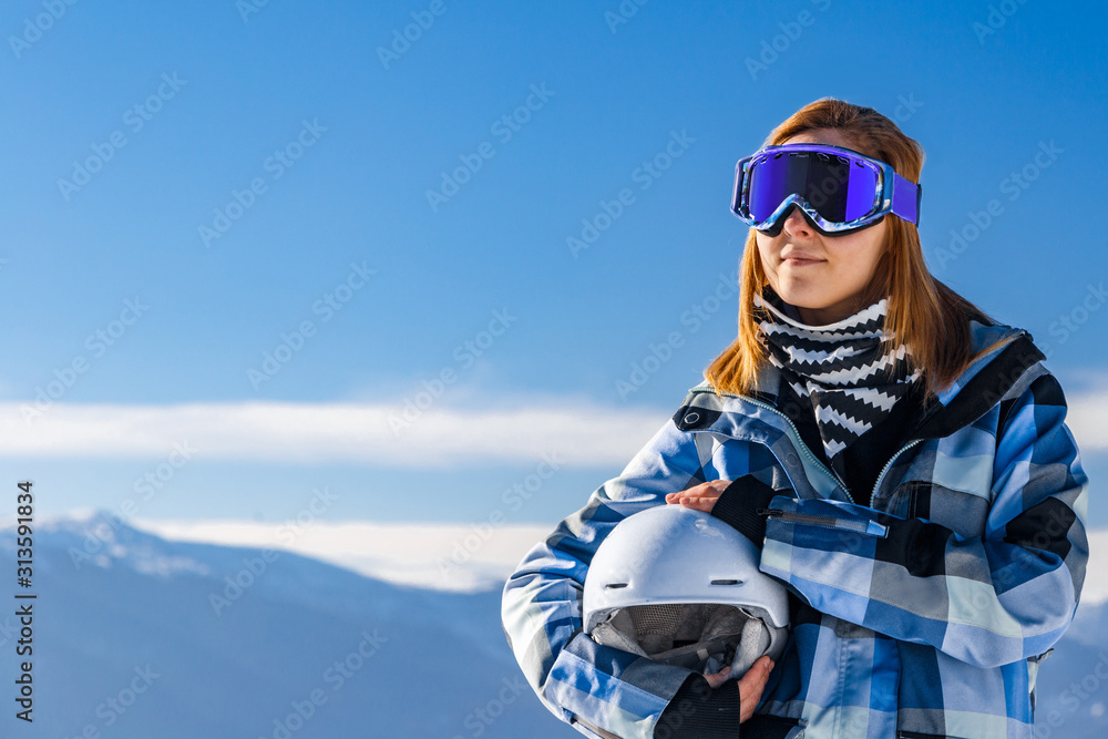 Skier girl on the background of high mountain Carpathians in Ukraine. Winter sport.