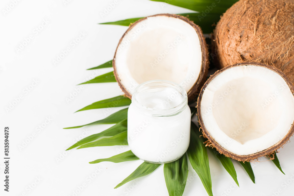 Ripe half cut coconut on a wooden background. Ripe half cut coconut on a wooden background. Coconut cream and oil. Ripe half cut coconut on a wooden background. Ripe half cut coconut on a wooden background. Coconut cream and oil.