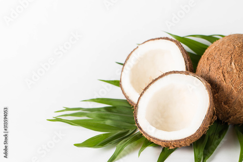 Ripe half cut coconut on a wooden background. Coconut cream and oil.