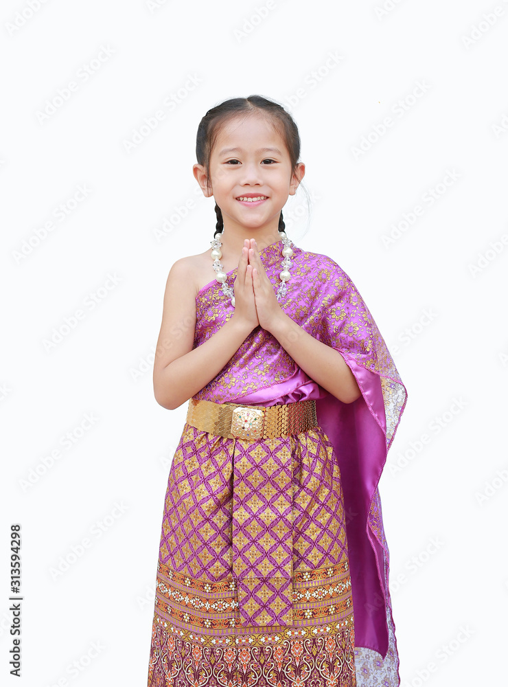 Beautiful Asian kid girl in traditional thai dress praying isolated on white background. (Sawasdee is meaning hello). Beautiful Asian kid girl in traditional thai dress praying isolated on white background. (Sawasdee is meaning hello).