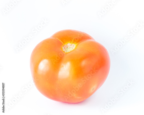 Studio shot one fresh cut organic Asian tomato isolated on white