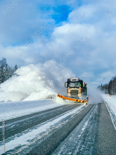 Картината върху платно Winter service truck for snow plow clearing road after winter snowstorm