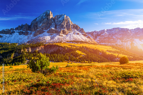 Stunning view of Peitlerkofel mountain from Passo delle Erbe in Dolomites, Italy. View of Sass de Putia (Peitlerkofel) at Passo delle Erbe, with wooden farm houses, Dolomites, South Tyrol, Italy.