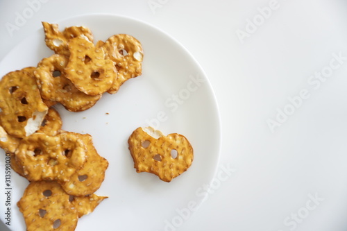 an image of pretzels on a plate on a white background after being eaten.