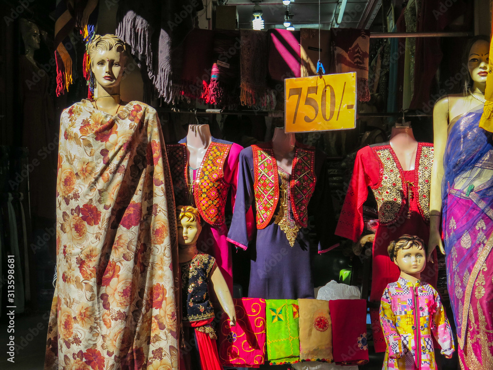 Woman and child mannequin wearing traditional nepali clothes in a street market store in Kathmandu, Nepal