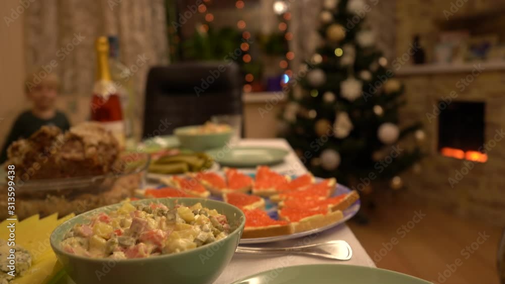 Dishes with food on the New Year's holiday table. New Year's holiday table. Salads, meat, alcohol on the New Year's table. Dishes with food on the New Year's holiday table. New Year's holiday table. Salads, meat, alcohol on the New Year's table.