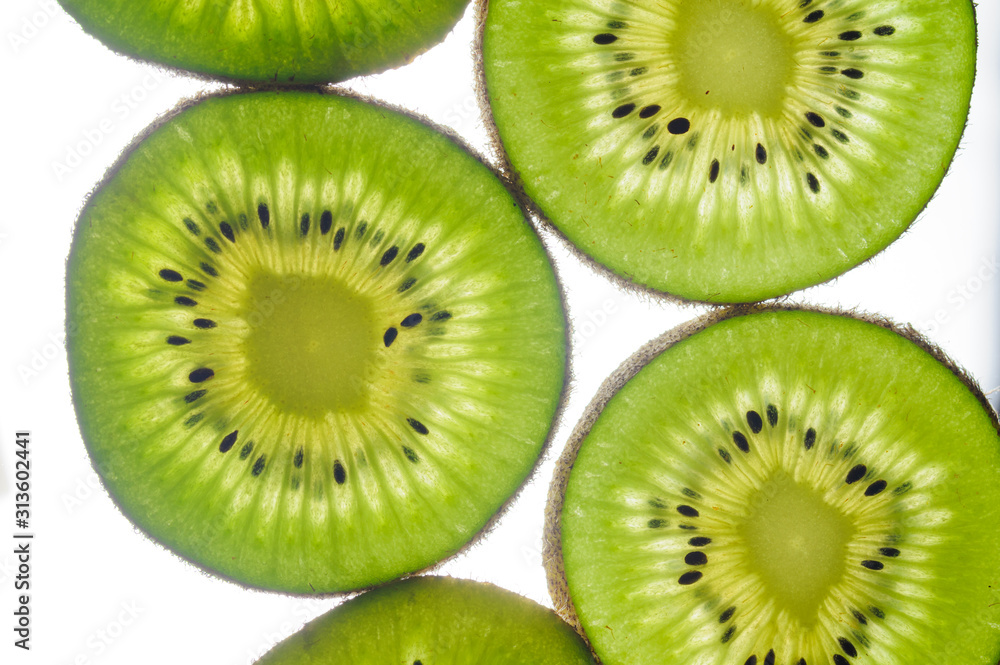 round kiwi slices on a white background. Isolated on white. close up round kiwi slices on a white background. Isolated on white. close up