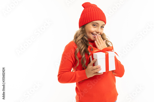 happy girl in a red hat with a gift with a red ribbon in hands on a white background