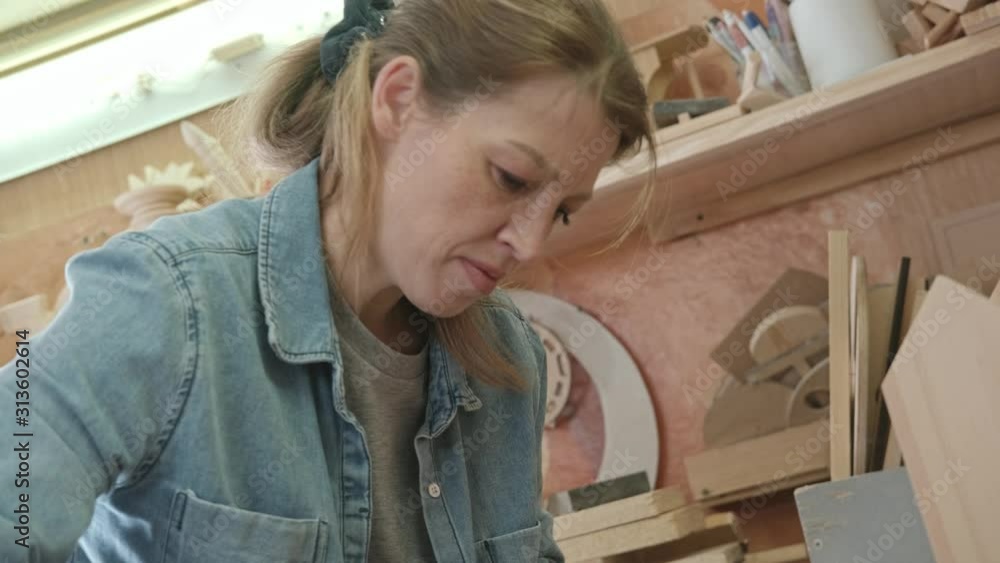 Woman woodworker makes an furniture at a little workshop. Woman woodworker makes an furniture at a little workshop.