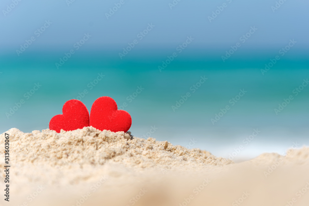 Valentine and Marry Concept. Two red hearts couple lovers for married wedding in summer day on sand paradise beach, blue background. Valentine and Marry Concept. Two red hearts couple lovers for married wedding in summer day on sand paradise beach, blue background.