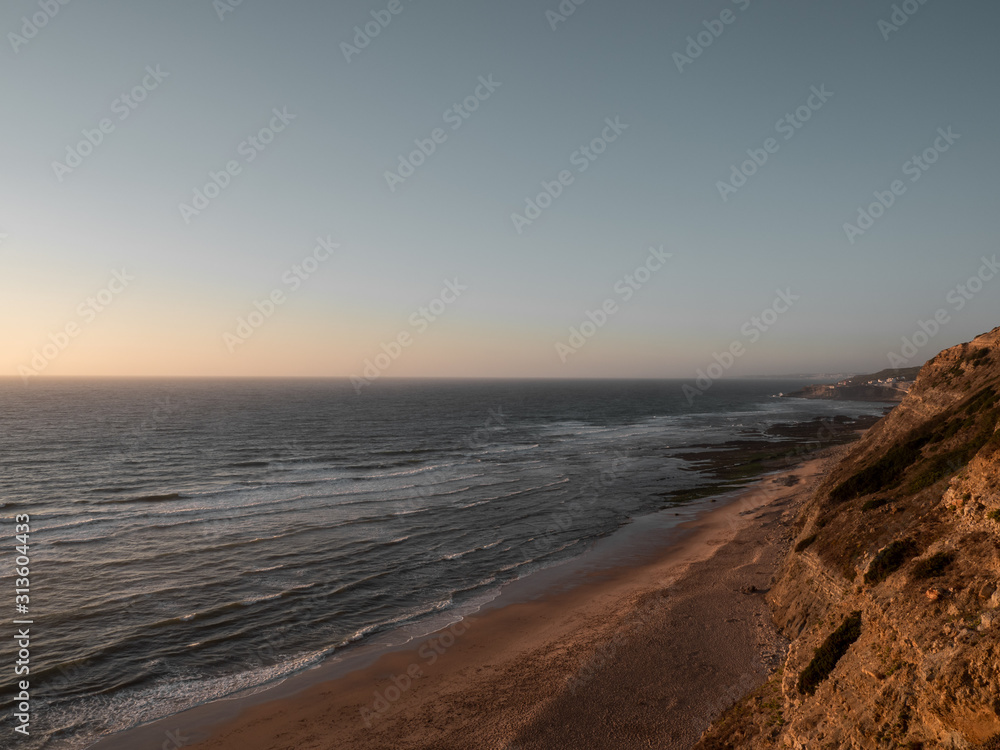Waves crashing on the beach at sunset Waves crashing on the beach at sunset