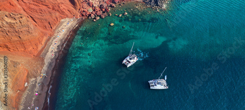 Aerial drone ultra wide photo of famous volcanic red beach in island of Santorini, Cyclades, Greece